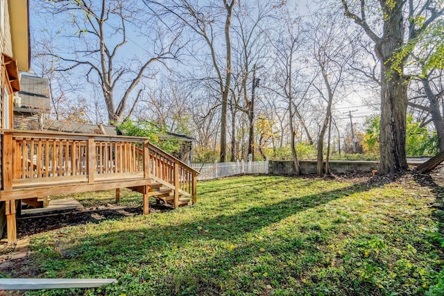 view of yard featuring a deck and fence