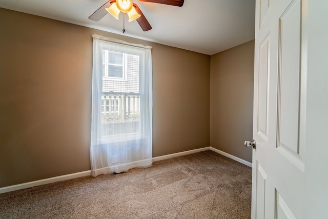 empty room with baseboards, carpet, and ceiling fan