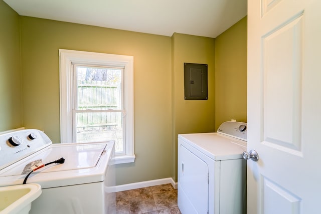 washroom featuring electric panel, laundry area, a healthy amount of sunlight, and washing machine and clothes dryer