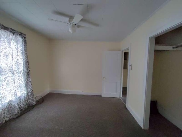 empty room featuring carpet, baseboards, and ceiling fan