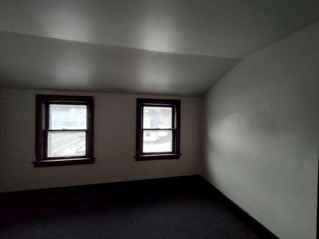 empty room featuring vaulted ceiling