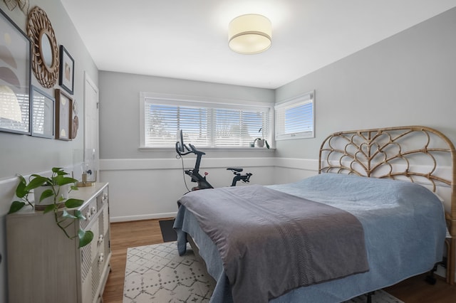 bedroom with wood finished floors and baseboards