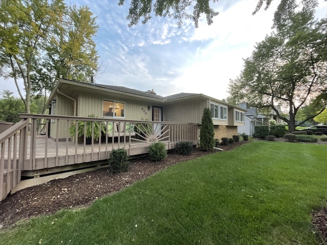 view of front of house featuring a deck and a front lawn