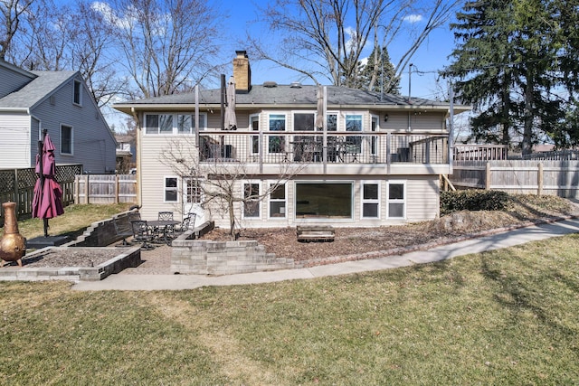 back of property featuring a patio area, a lawn, fence, and a chimney