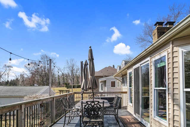 wooden terrace with outdoor dining area