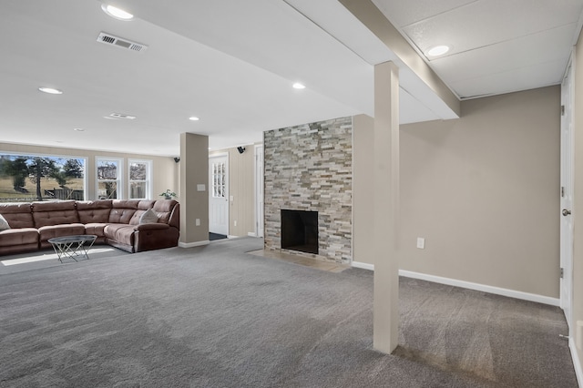 living area featuring visible vents, carpet floors, baseboards, and a fireplace