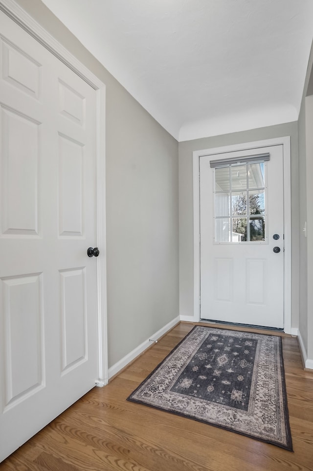 entrance foyer with baseboards and wood finished floors