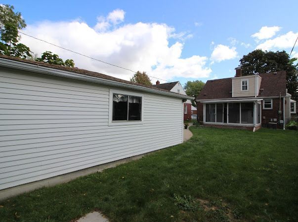 exterior space with a yard and a sunroom