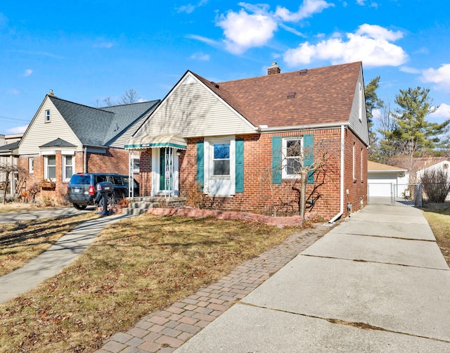 bungalow featuring fence, brick siding, roof with shingles, and a chimney