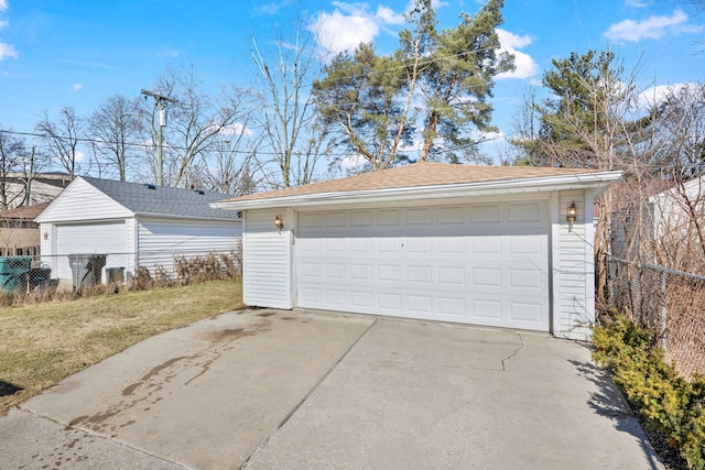 detached garage featuring fence