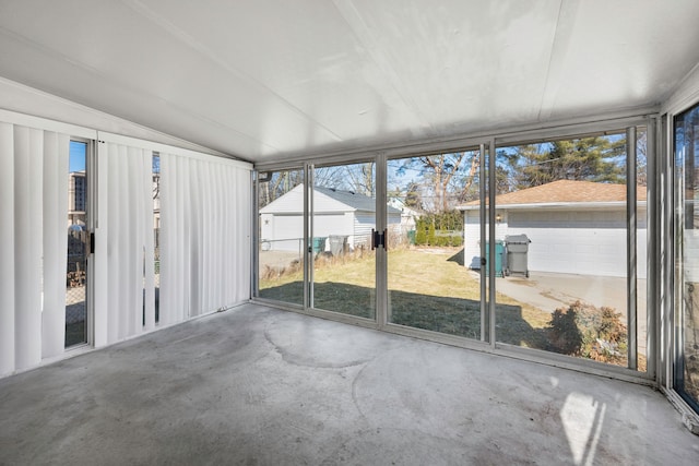 unfurnished sunroom featuring vaulted ceiling