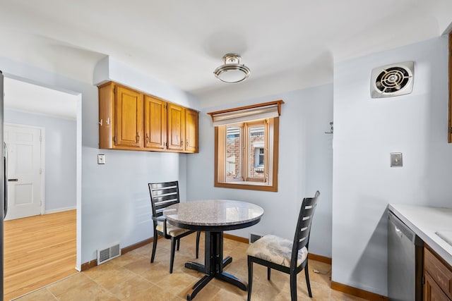 dining room with light tile patterned floors, visible vents, and baseboards