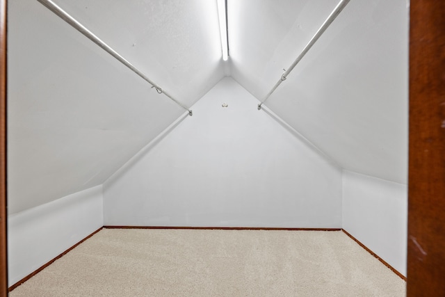 additional living space featuring vaulted ceiling, baseboards, and carpet floors