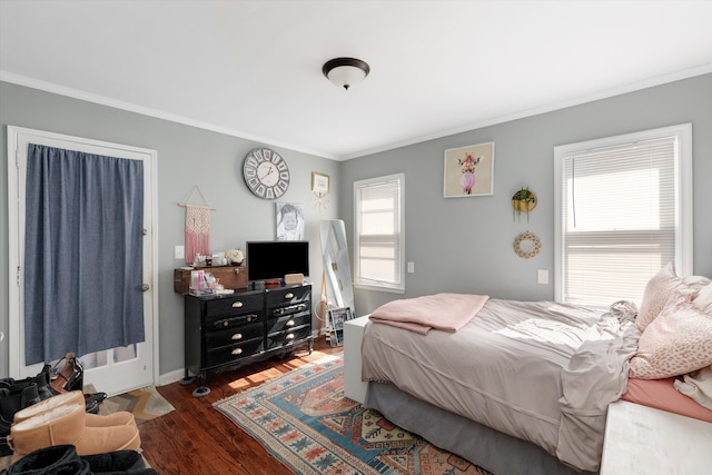 bedroom featuring wood finished floors, baseboards, and ornamental molding