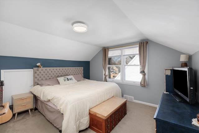 bedroom featuring visible vents, baseboards, light colored carpet, and vaulted ceiling