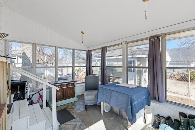 sunroom / solarium with lofted ceiling and a healthy amount of sunlight