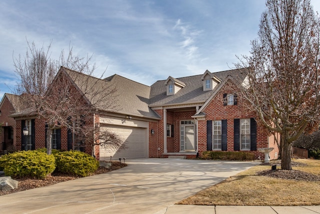 view of front of house with driveway, brick siding, roof with shingles, and an attached garage