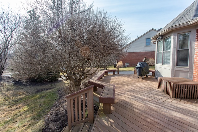 wooden deck with a grill