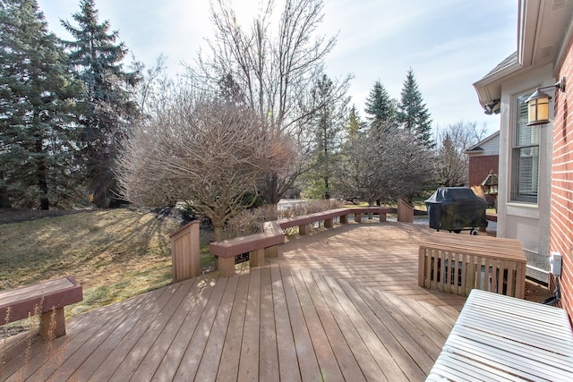 wooden terrace featuring a grill