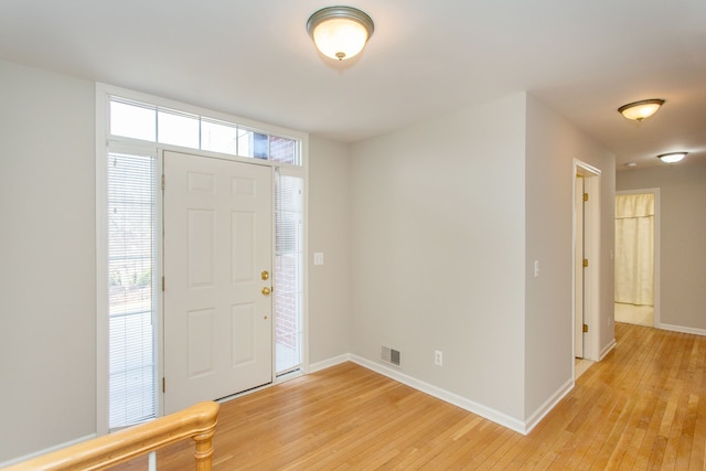 entryway with a healthy amount of sunlight, light wood-type flooring, and baseboards