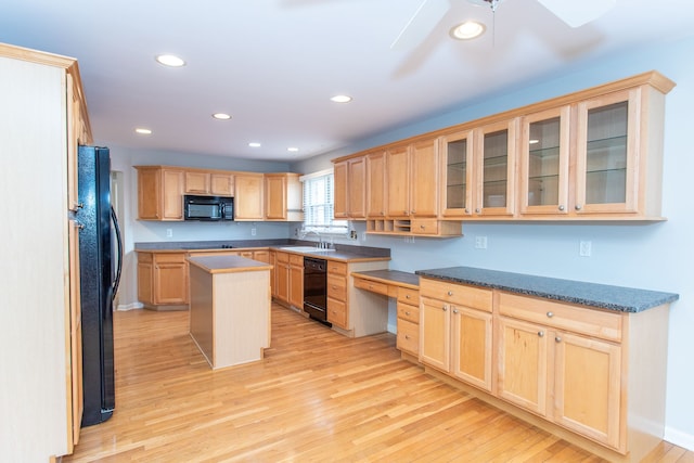 kitchen featuring light brown cabinets, recessed lighting, light wood-style flooring, black appliances, and a sink