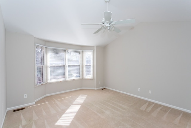 unfurnished room with visible vents, light colored carpet, and baseboards