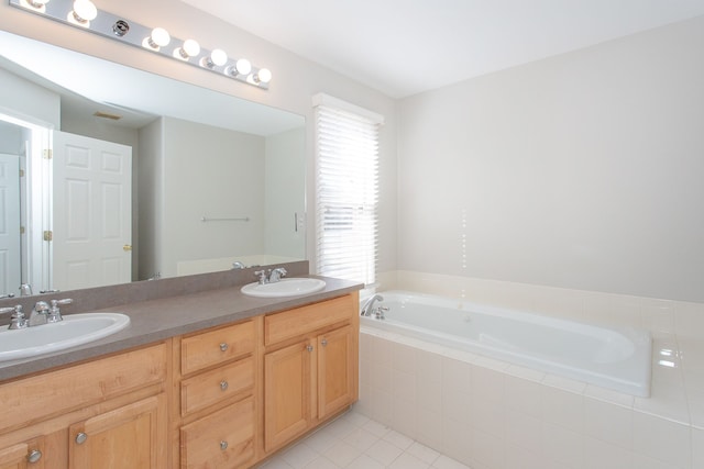 full bath with a sink, a garden tub, double vanity, and tile patterned flooring