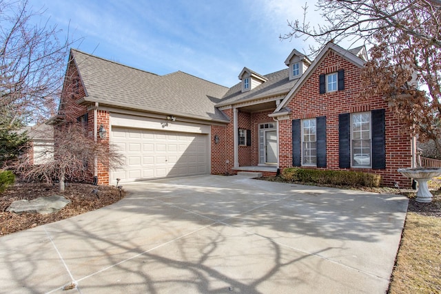 view of front of property with brick siding, concrete driveway, a garage, and roof with shingles