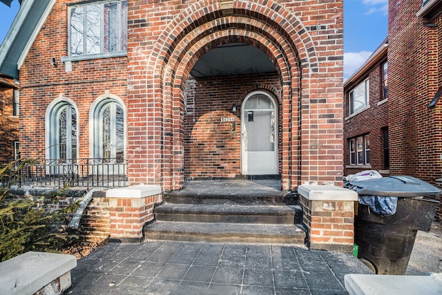 view of exterior entry with brick siding