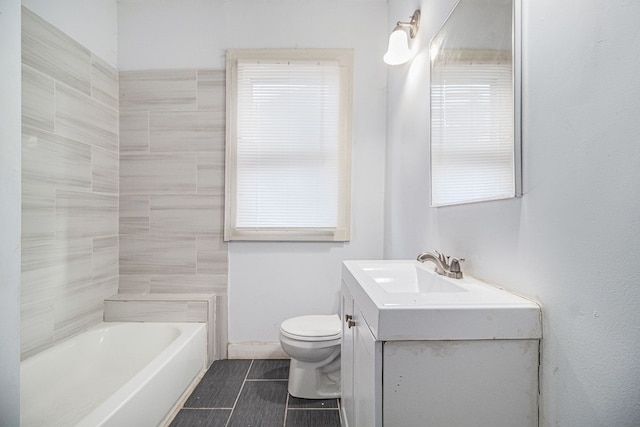 bathroom featuring a bathing tub, toilet, and vanity