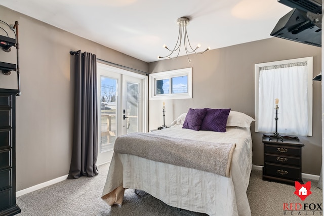 bedroom featuring access to exterior, french doors, baseboards, and a chandelier