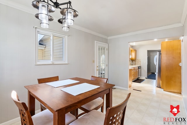 dining room with baseboards, light floors, an inviting chandelier, and ornamental molding