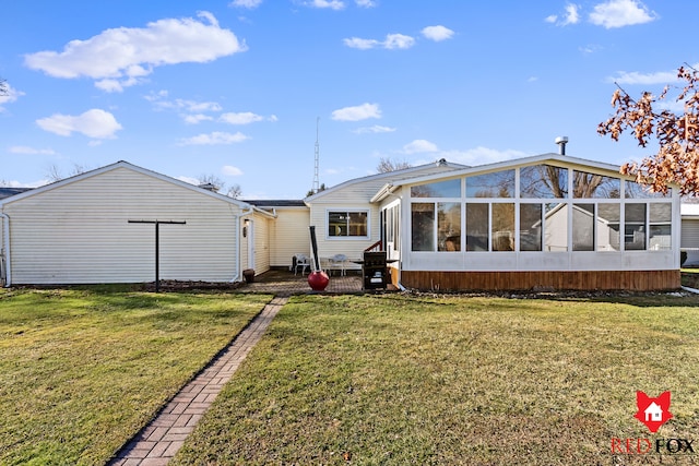 back of property featuring a lawn and a sunroom