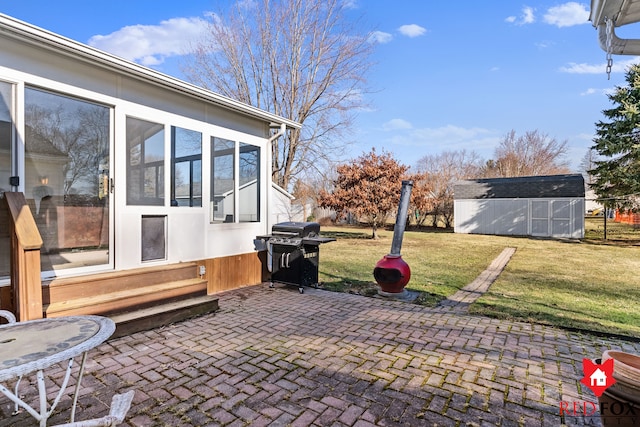 view of patio with area for grilling, an outdoor structure, and entry steps