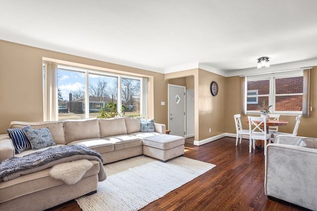 living room featuring baseboards and dark wood finished floors