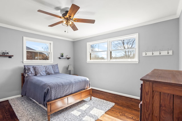 bedroom with ceiling fan, baseboards, wood finished floors, and ornamental molding