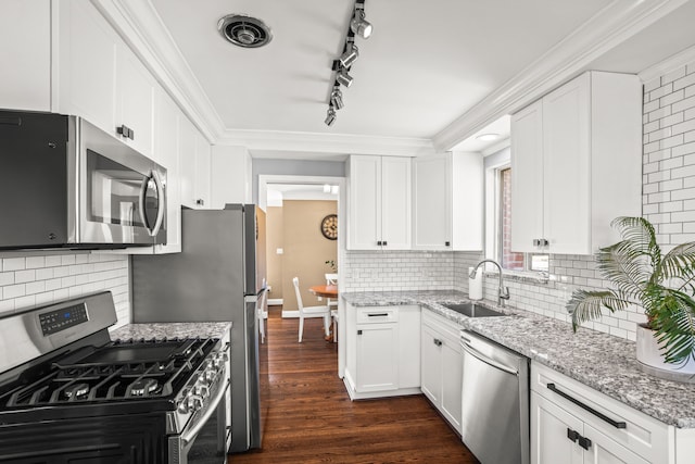 kitchen with visible vents, dark wood finished floors, white cabinets, stainless steel appliances, and a sink