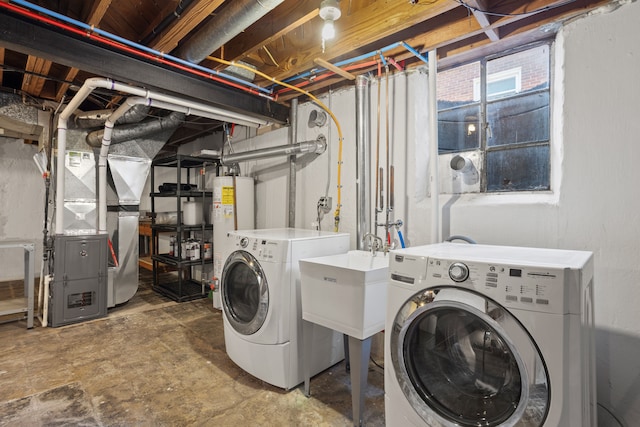 clothes washing area with laundry area, heating unit, separate washer and dryer, and water heater