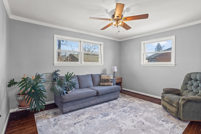 living area with a wealth of natural light, ceiling fan, dark wood-type flooring, and baseboards