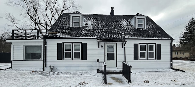 cape cod-style house with a chimney