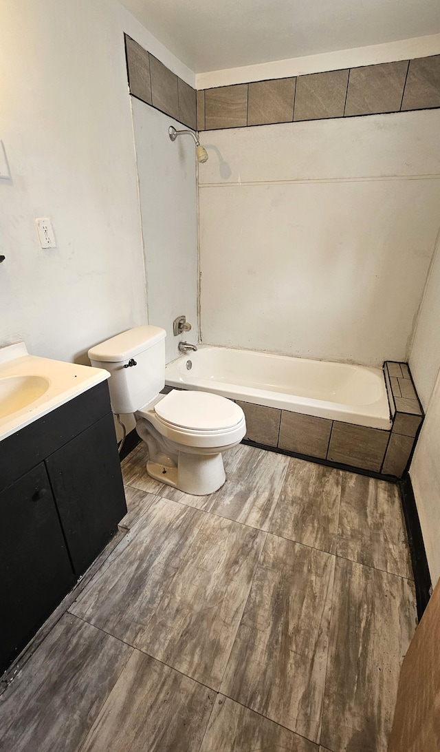 bathroom with vanity, toilet, and shower / bath combination