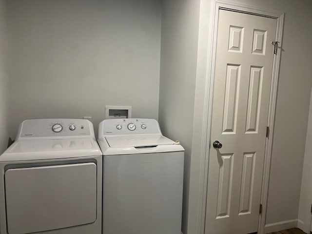 clothes washing area featuring washing machine and dryer and laundry area