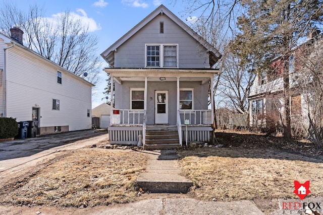 view of front facade with covered porch, concrete driveway, a garage, and stucco siding