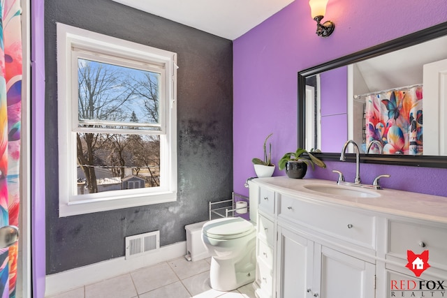 bathroom with vanity, tile patterned floors, toilet, and visible vents