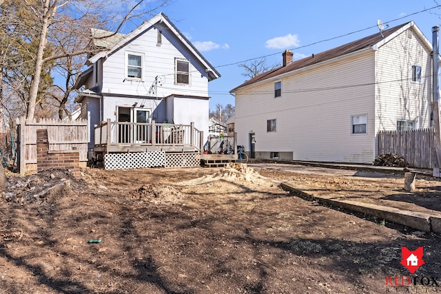 back of house with a wooden deck and fence