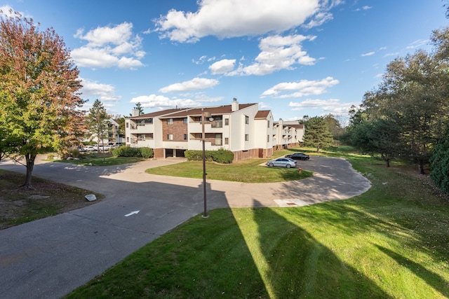 view of community featuring a yard and a residential view