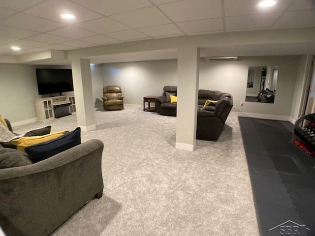 living room with recessed lighting, carpet, baseboards, and a paneled ceiling