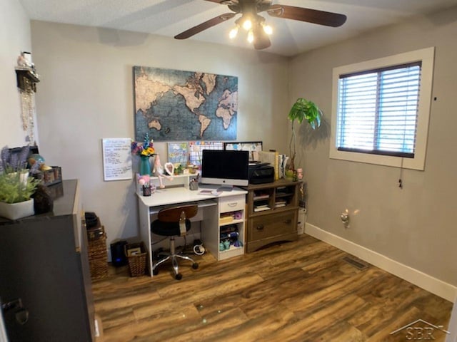 office space with a ceiling fan, baseboards, and wood finished floors