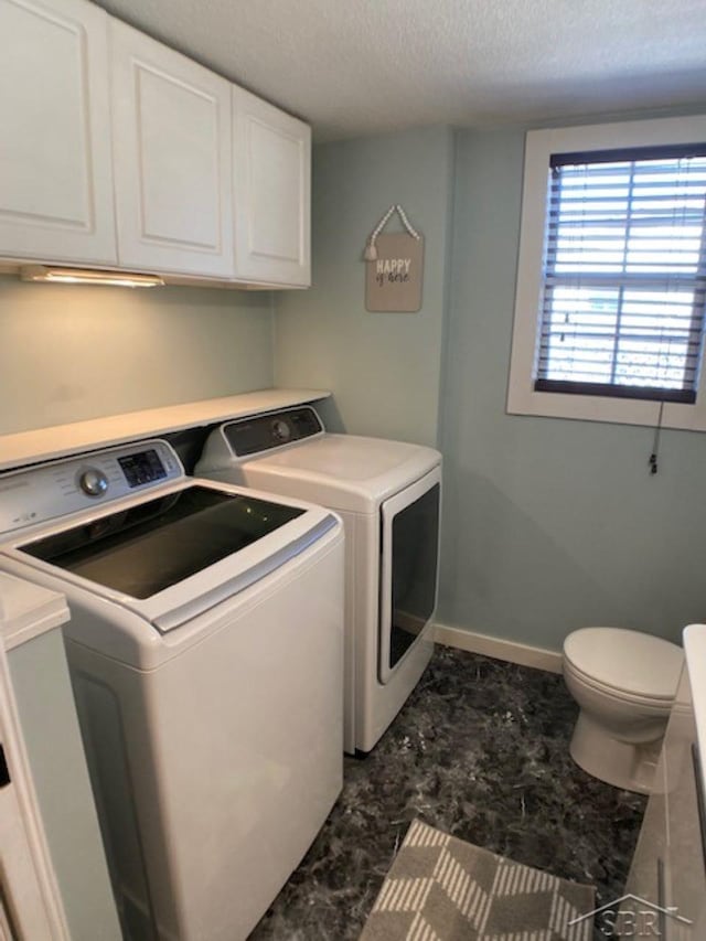 laundry room with baseboards, a textured ceiling, independent washer and dryer, and laundry area