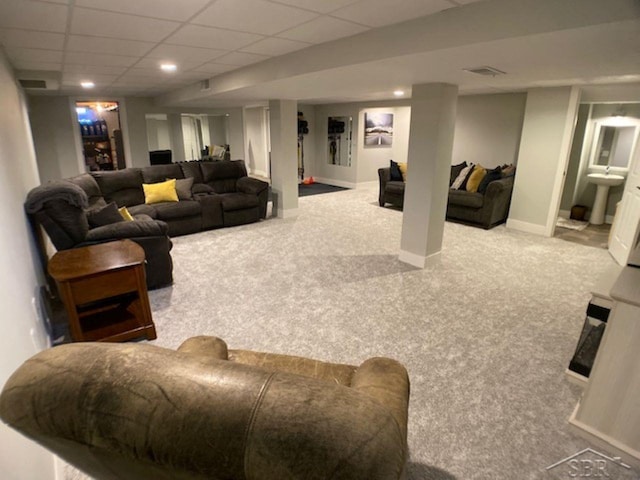 living area featuring visible vents, baseboards, carpet floors, recessed lighting, and a paneled ceiling